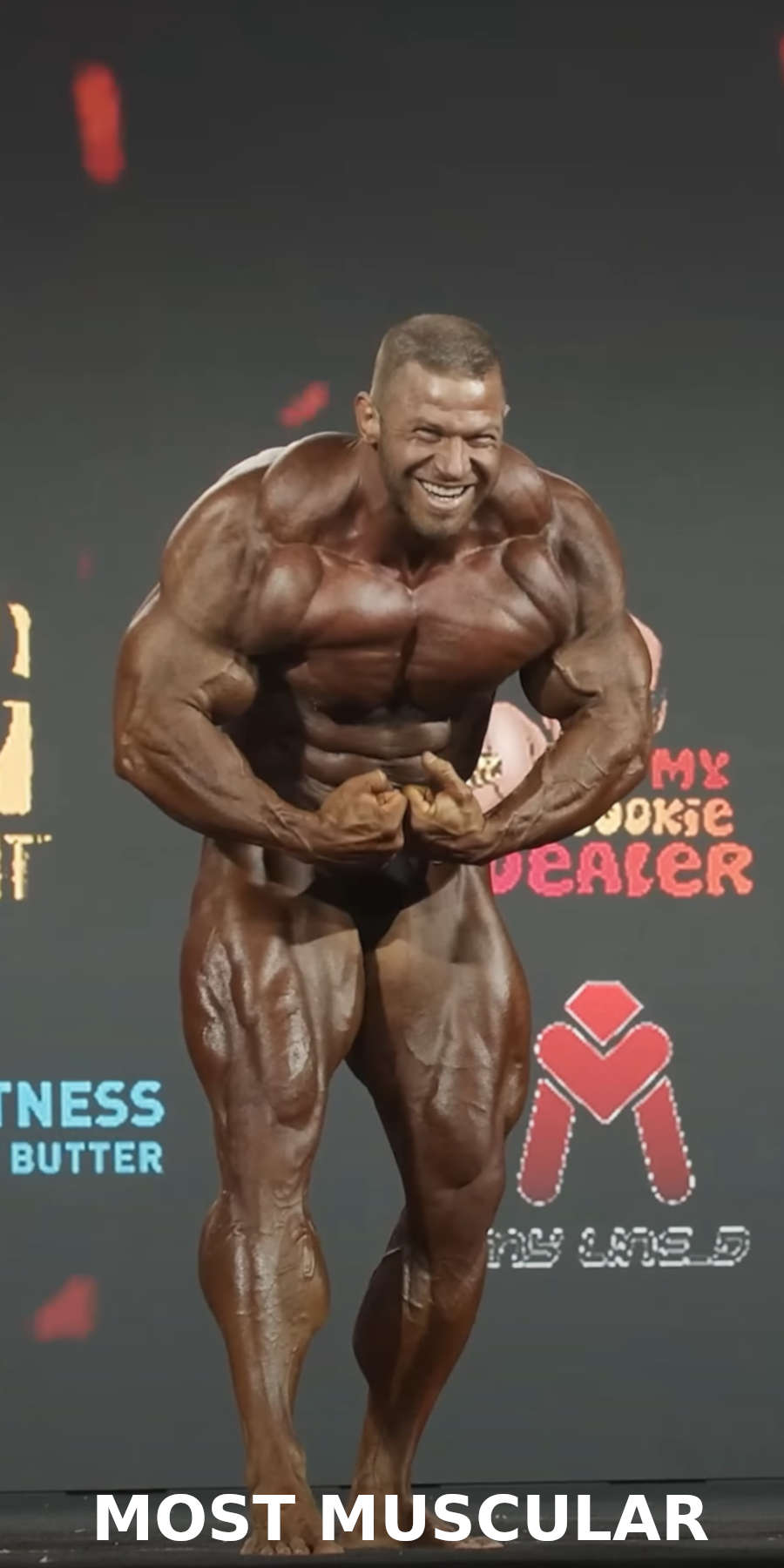 A bodybuilder performing the most muscular pose on stage during a bodybuilding competition 