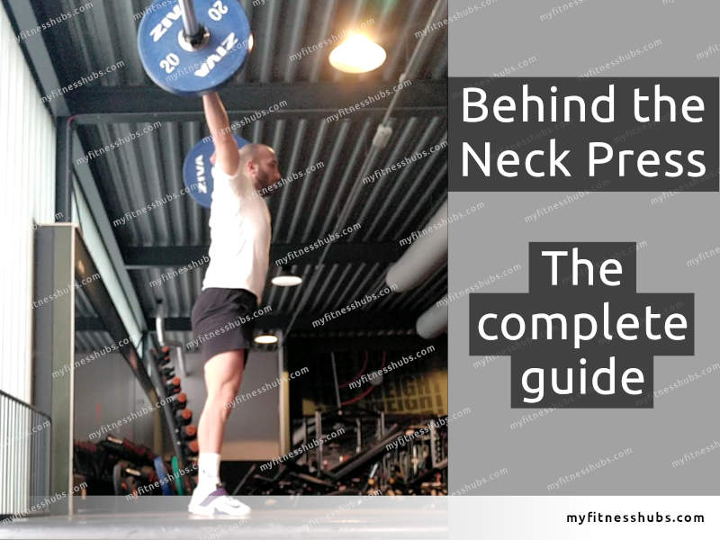 Side view of a fit, male athlete doing the Behind the Neck press in a commercial gym.